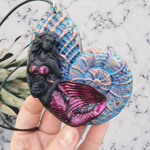 Mermaid on seashell hand